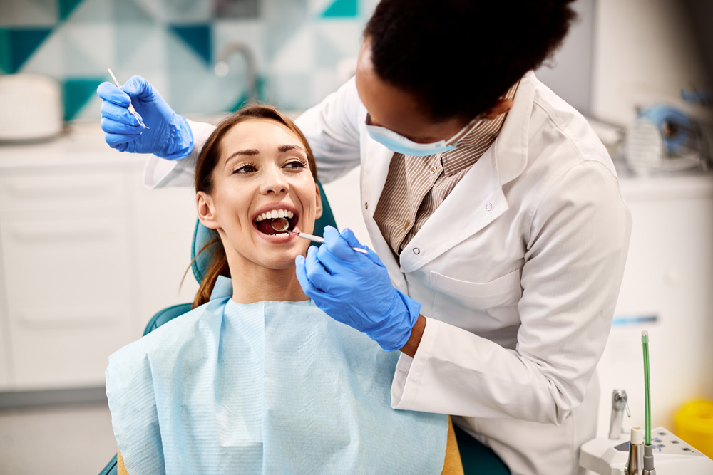 woman having her teeth examined during dental appointment