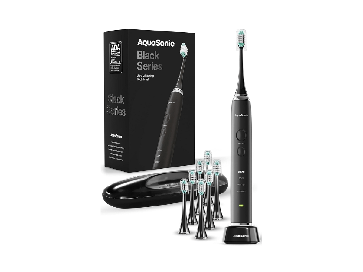 AquaSonic Black Series Ultra-Whitening electric toothbrush with multiple brush heads, travel case, and charging base, featuring ADA acceptance and advanced sonic cleaning technology.