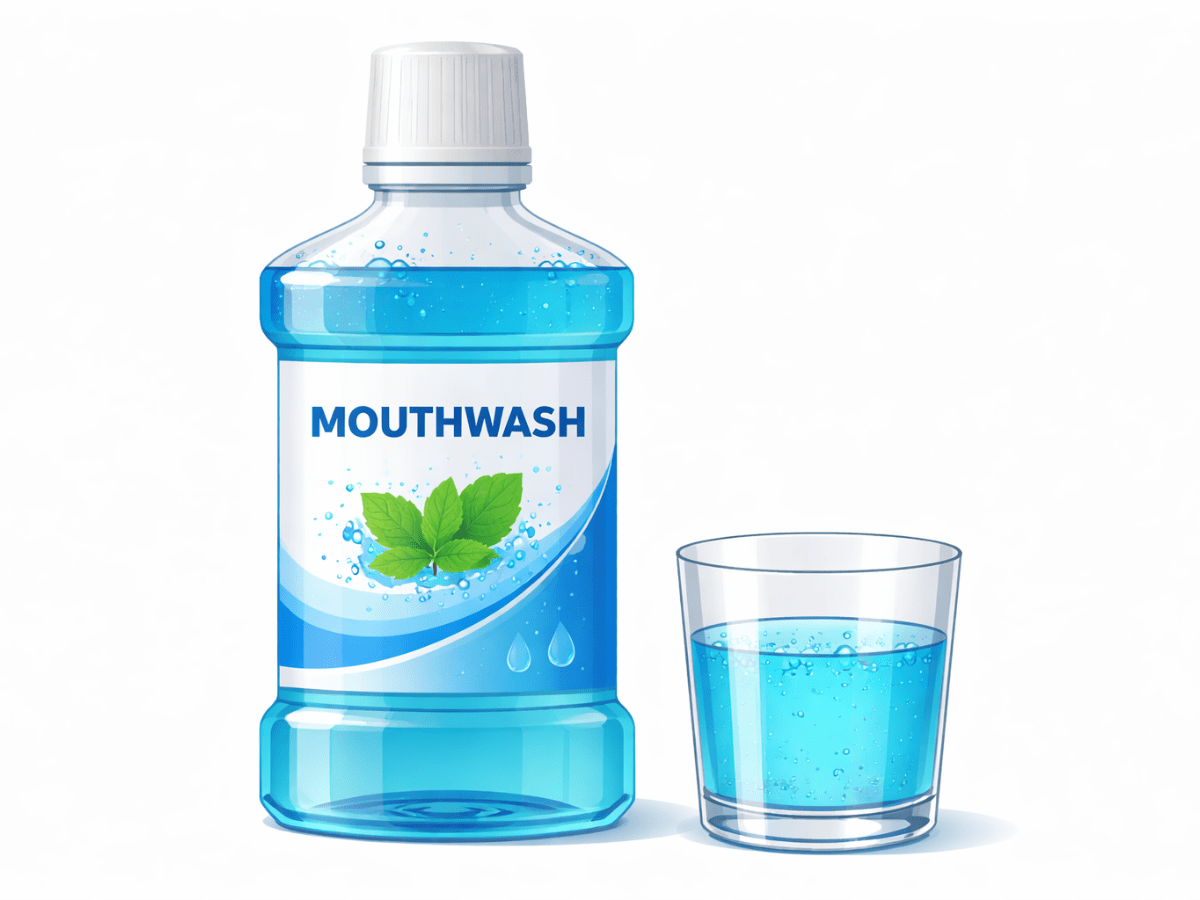 Bottle of blue mouthwash with a small glass for rinsing, commonly used to support oral hygiene and fresh breath