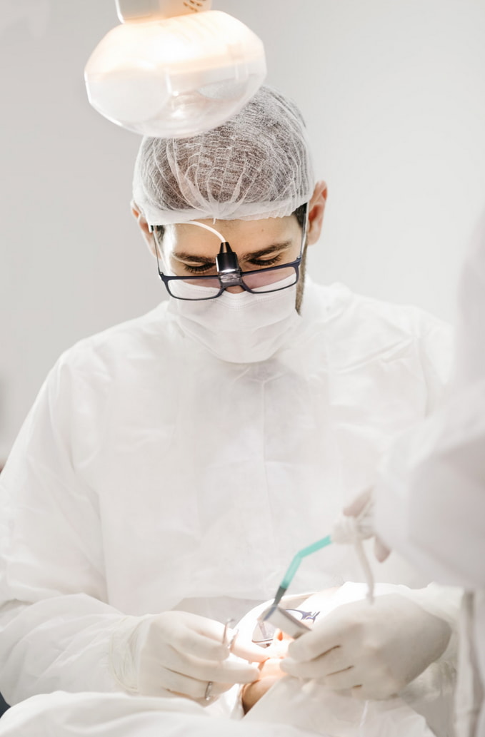 A dentist looking into a patient’s mouth. 