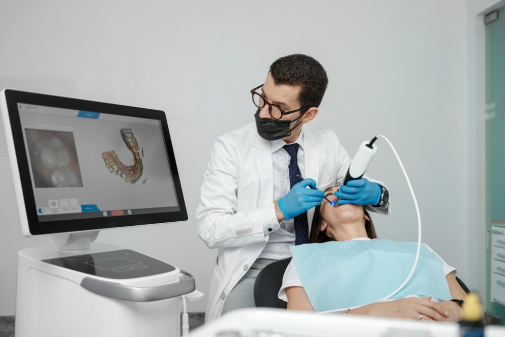 A dentist examines a patient in a dental office, surrounded by dental tools and equipment. 
