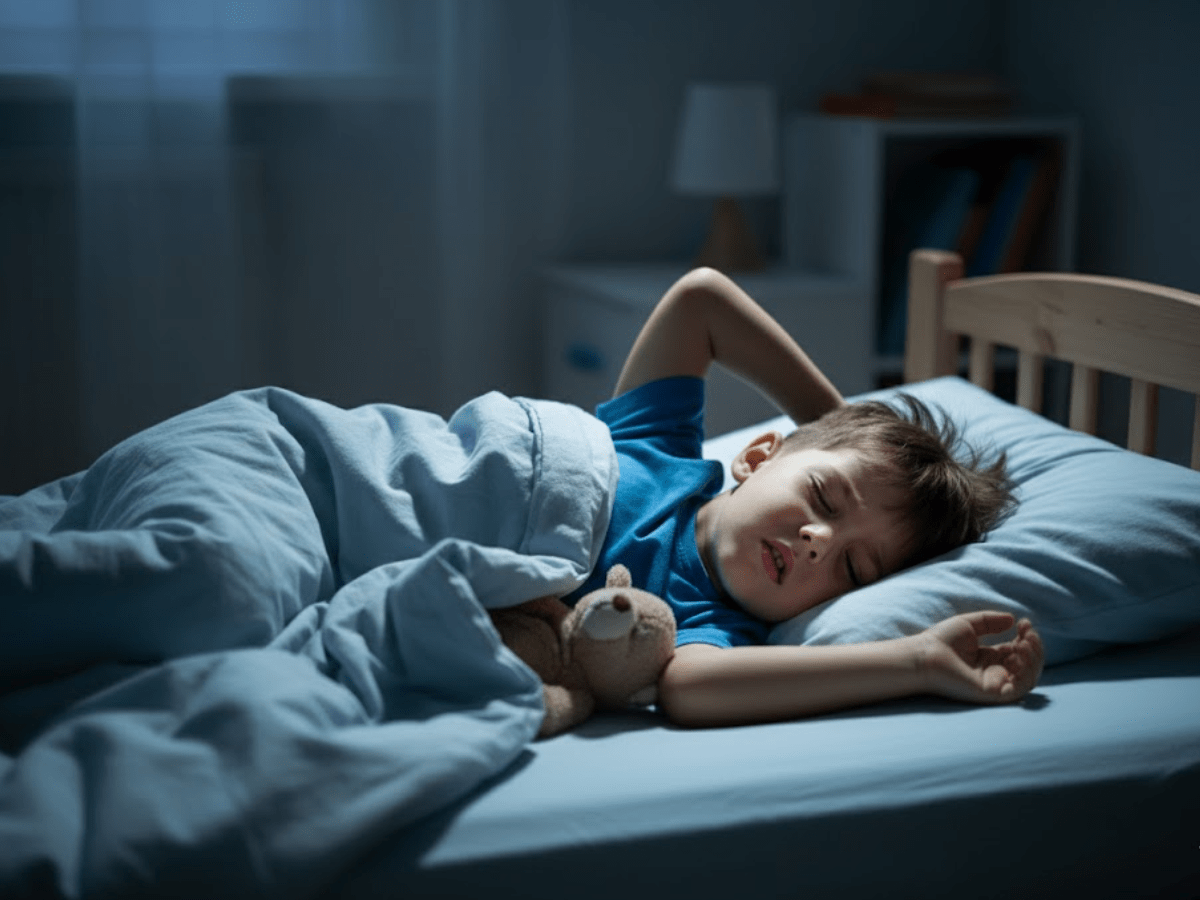 Young boy sleeping in bed at night with a pained facial expression, suggesting discomfort or restless sleep.