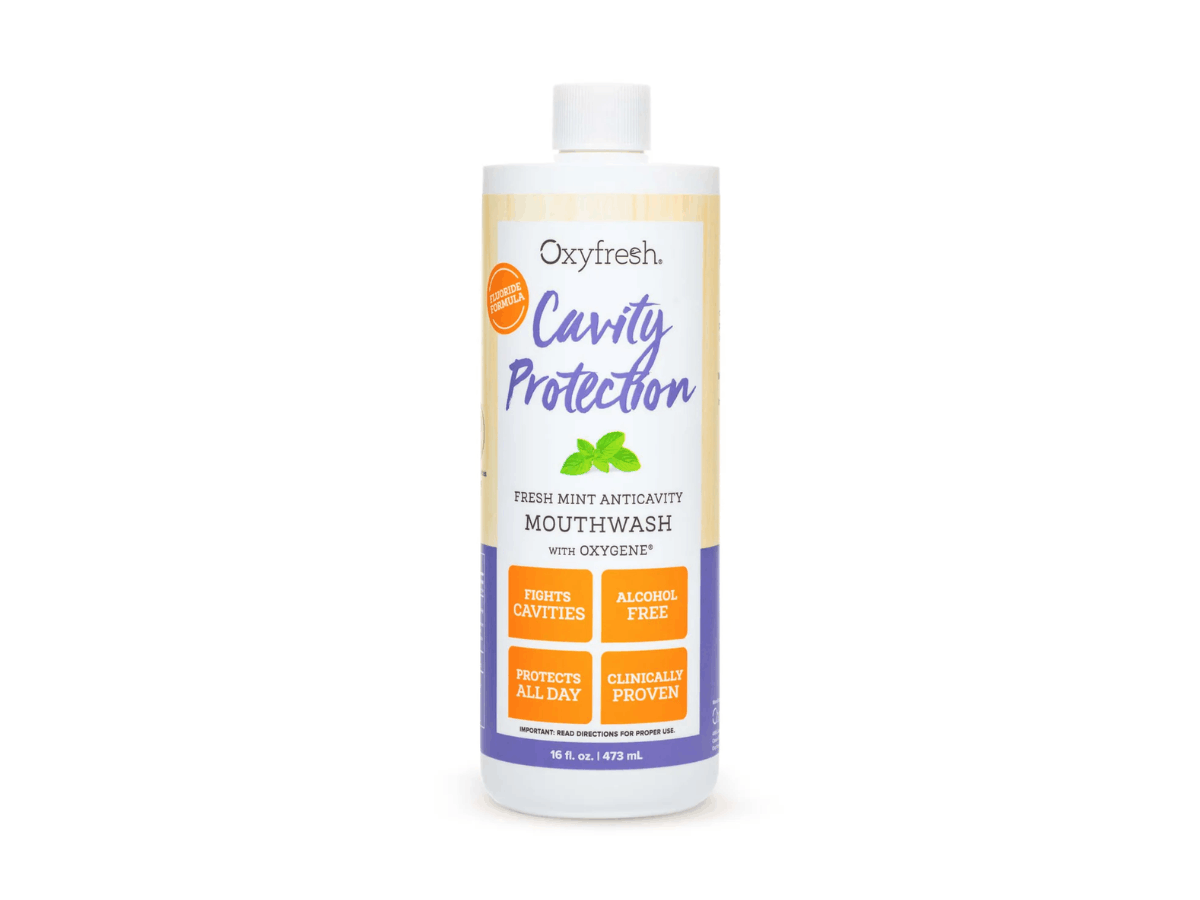 Bottle of Oxyfresh Cavity Protection fluoride mouthwash in Fresh Mint, alcohol-free anticavity rinse for daily cavity prevention